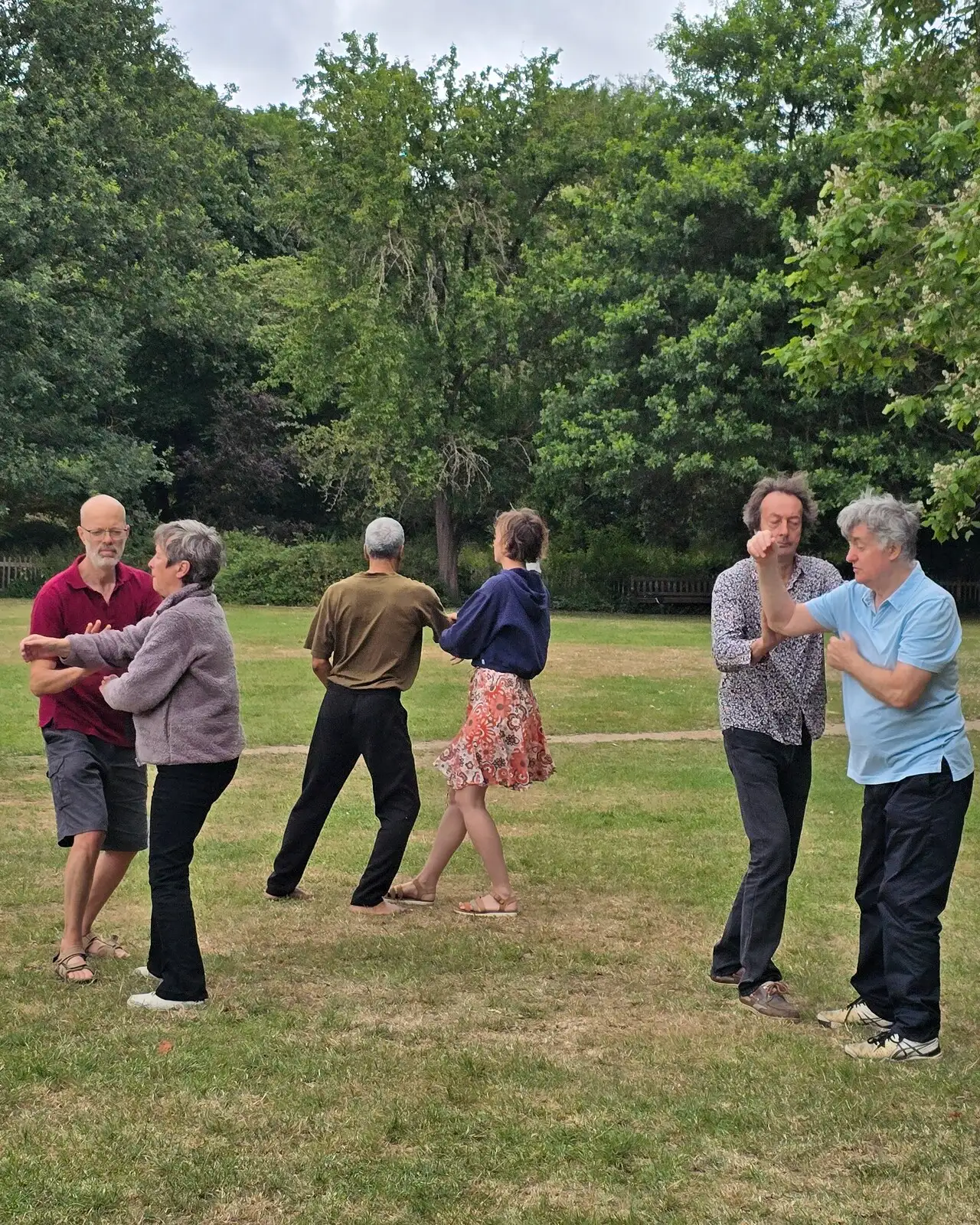 Pushing hands during a morning Taiji class in Holland Park, London